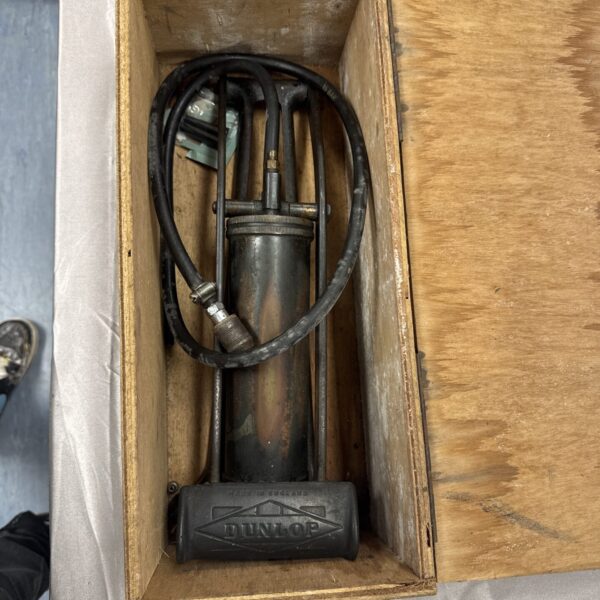 Vintage brass Dunlop tyre inflator with black hose.
