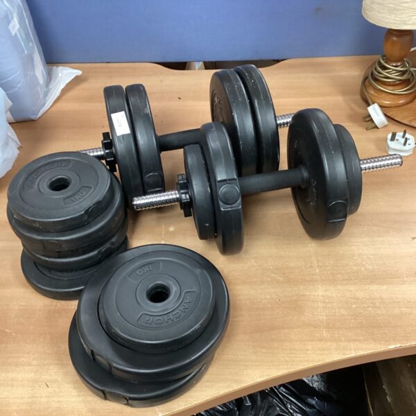 Pair of circular dumbbell weights for strength training.