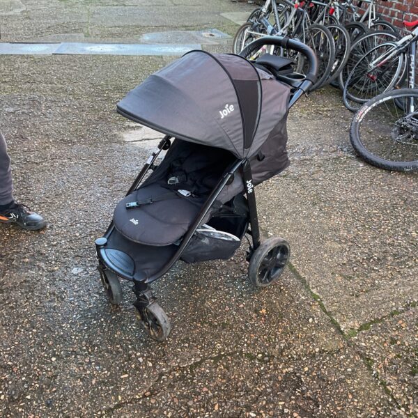 Jole pushchair with protective cover, side view.