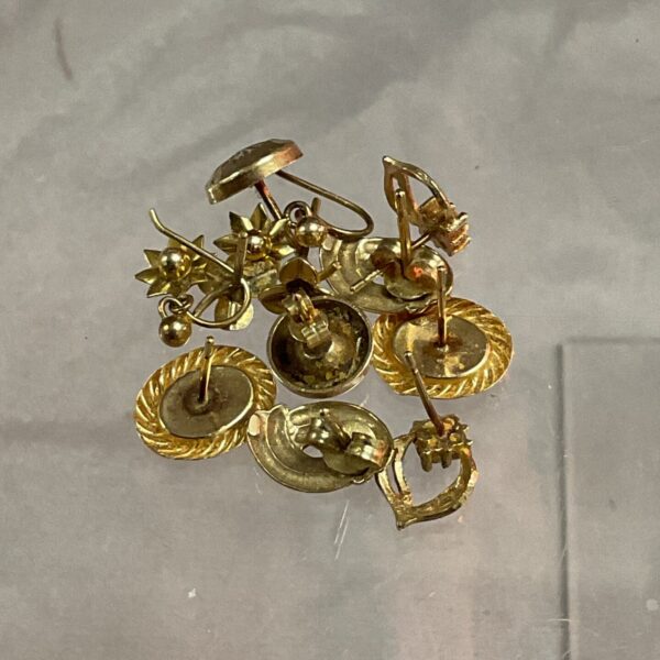 Close-up of 9ct gold scrap earring components for refining.