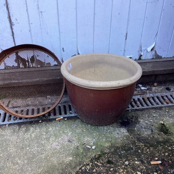 Glazed terracotta garden planter with weathered finish.