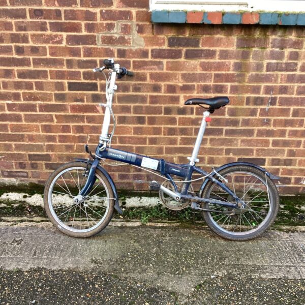 Vintage Dahon folding bike needing restoration, ideal for commuters.