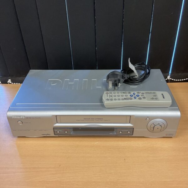 Front view of a black Philips VR730 VCR with remote control.