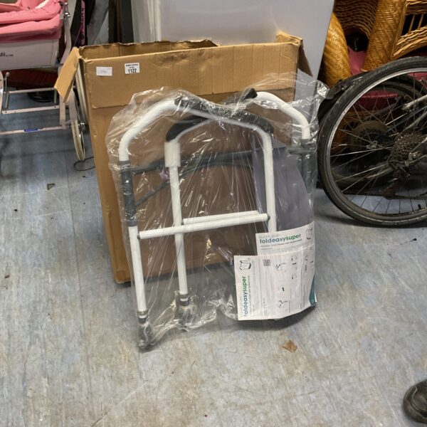 Foldeasysuper mobility toilet frame in plastic wrapping.