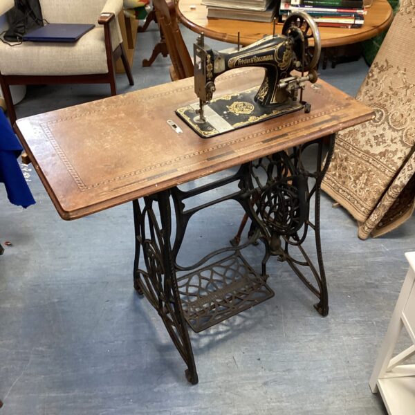 Vintage Fister & Rossman sewing machine on treadle table