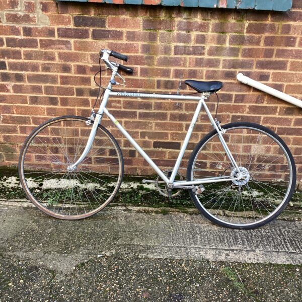 Silver Peugeot street bike, vintage French bicycle for urban use.