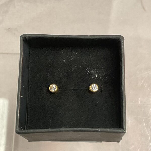 Close-up of 9ct gold stud earrings with white stones in a presentation box.