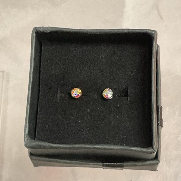 Close-up of 9ct gold stud earrings with coloured stones in a presentation box.