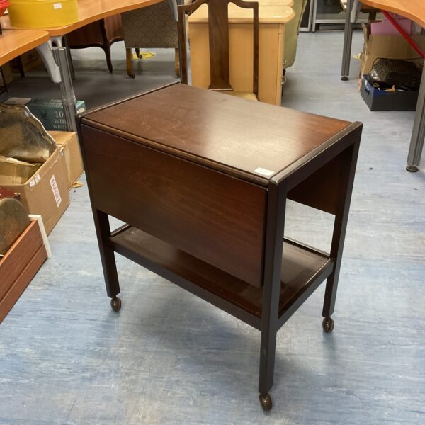 Vintage mahogany drop leaf butler’s trolley with folding leaves.