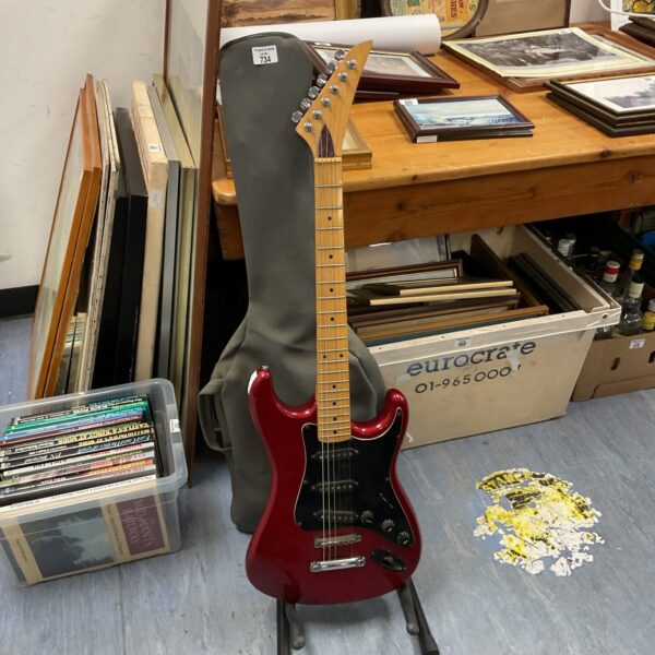 Red electric guitar with hard case, vintage musical instrument.