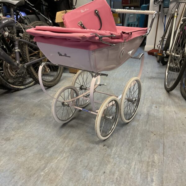Cream vintage Silver Cross pram with bag, classic nursery carriage.