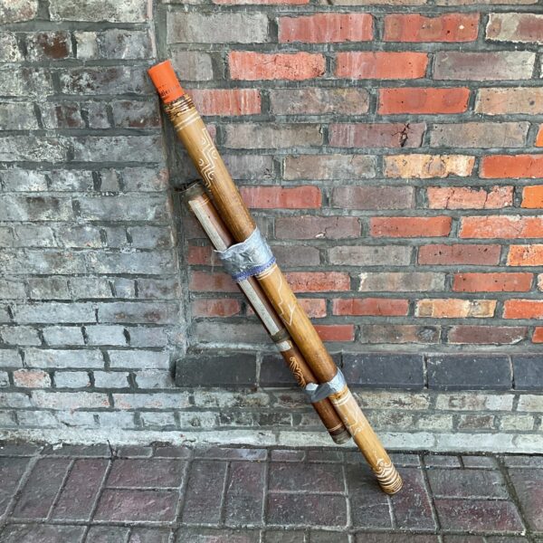 Authentic Aboriginal didgeridoo with rain maker and sheet music.