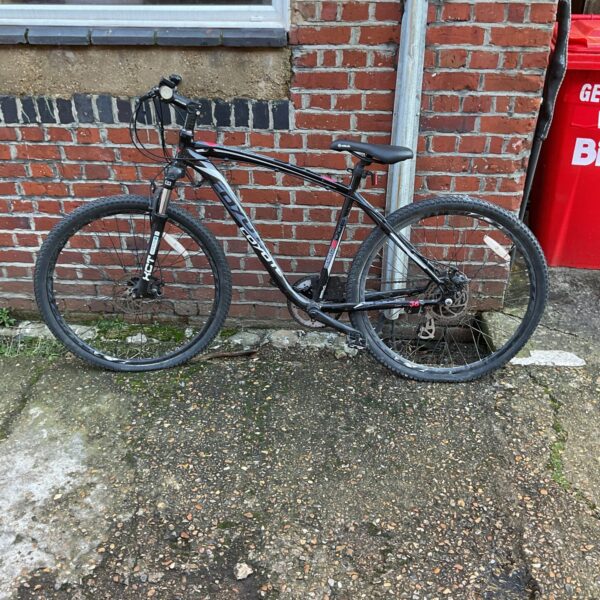 Black Coyote mountain bike for auction, ideal for off-road adventures.