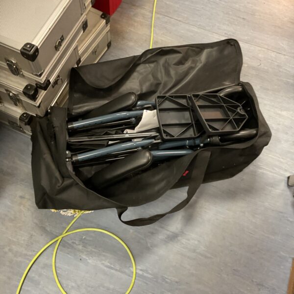 Folded Drive wheelchair with carry bag, showing portability.