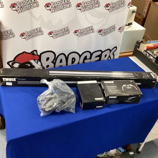 Used Thule Wingbar roof rack system with attachments.