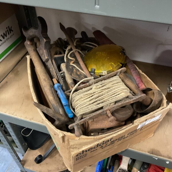 Vintage tool lot with hammer, wrenches, and rope.