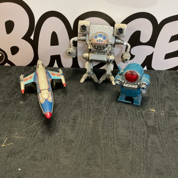 Vintage lot of three toys including a robot and rocket.