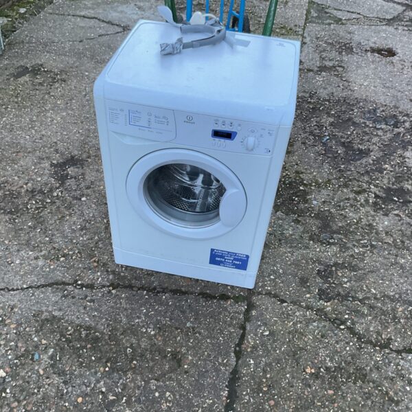 White Indesit washing machine front view, used appliance.