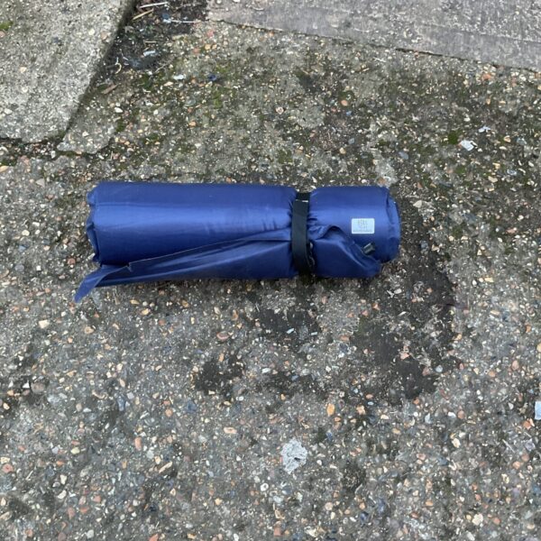 Single inflatable bed, showing signs of use, ready for camping or guests.