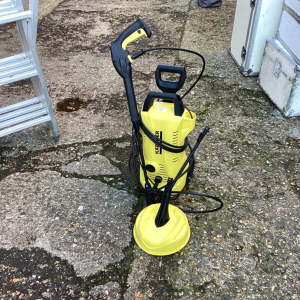 Yellow Karcher power washer for garden and patio cleaning.