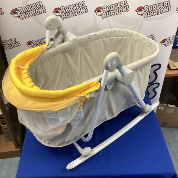 Side view of a Kinderkraft baby rocker in a nursery setting.