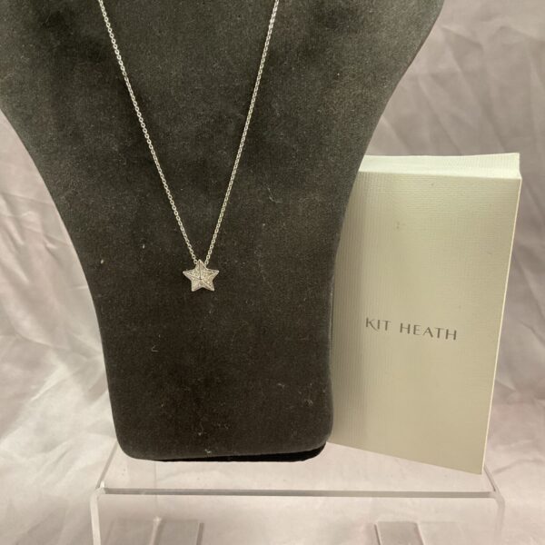 Kit Heath silver star pendant necklace on a neutral background.