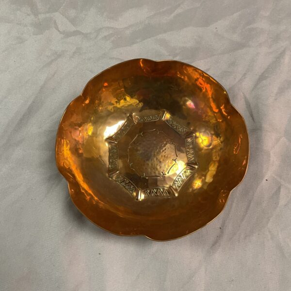 Overhead view of antique LCMI hand beaten copper dish.