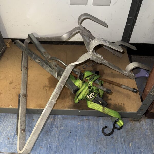 Vintage metal ladder stay for roof safety and stability.