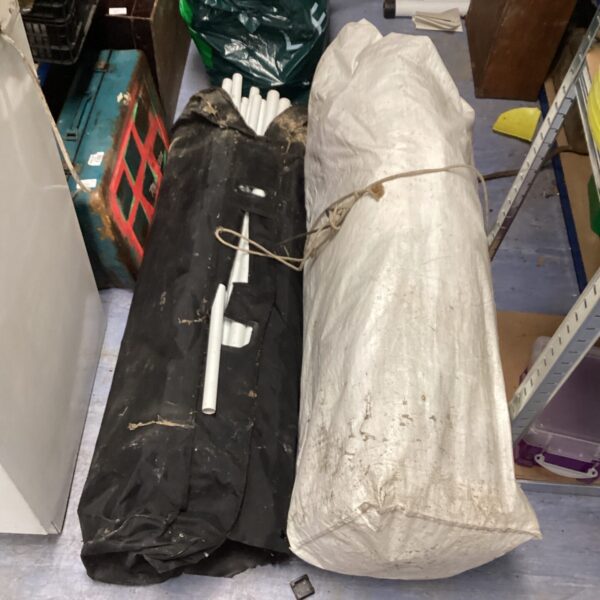 Large storage bags for a gazebo, ready for garden use.
