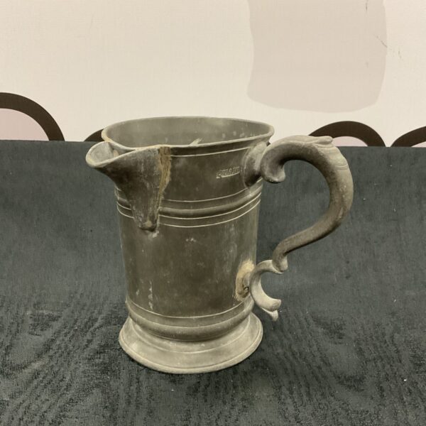 Large antique Georgian pewter tankard with a sturdy handle.