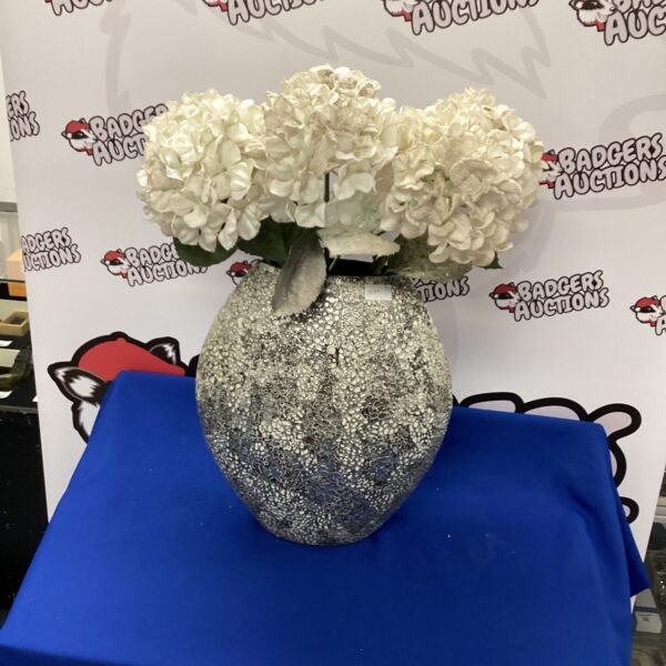 Large modern ceramic vase with white artificial flowers.