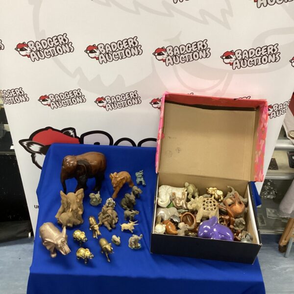 Large collection of ceramic elephant ornaments and figurines.