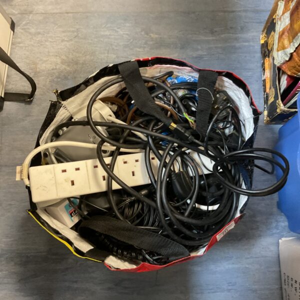 Mixed lot of cables and power supplies for electronic projects.