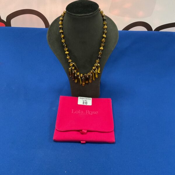 Lola Rose London tiger eye bead necklace on a neutral background.