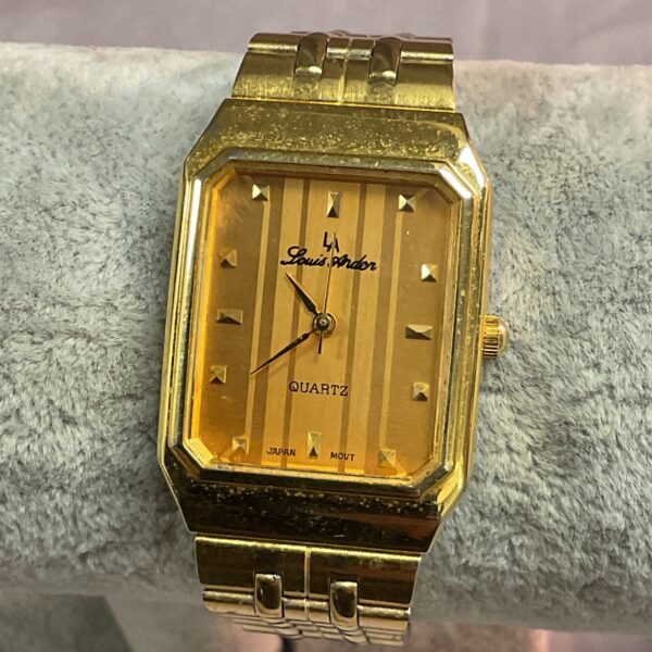 Gold tone Louis Arden quartz wristwatch, vintage fashion accessory.