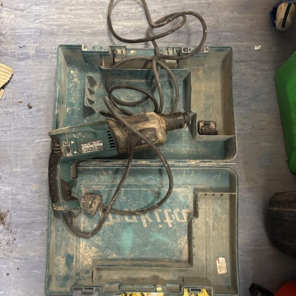 Makita HR2470 drill in original carry case, showing signs of use.