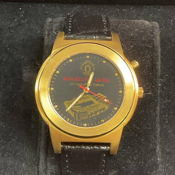 Front view of vintage Manchester United OT100 watch with Old Trafford image.