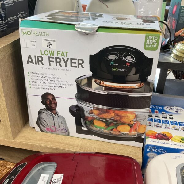 Front view of a white and red Mo Health air fryer.