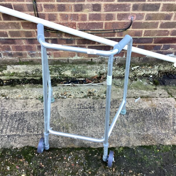 Silver mobility walker with four wheels, a helpful walking aid.