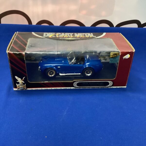 Blue diecast Cobra model car in original packaging.
