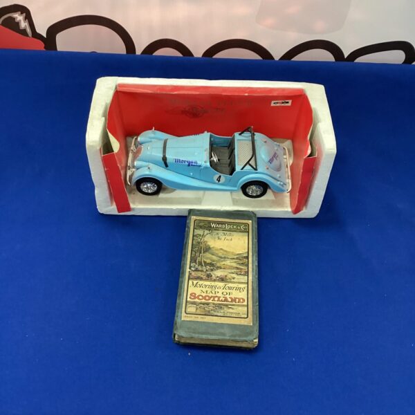 Vintage model Morgan sports car with wardlock map of Scotland.