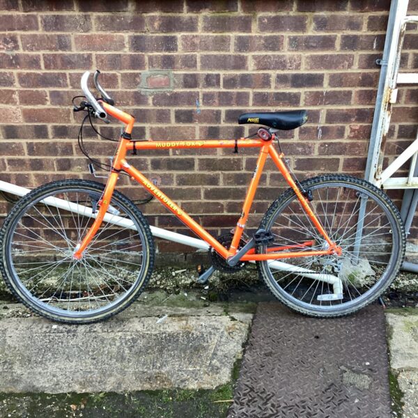 Vibrant orange vintage Muddy Fox mountain bicycle.