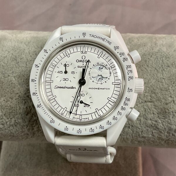 White Omega Swatch Moonwatch Snoopy bioceramic watch with moonphase dial.
