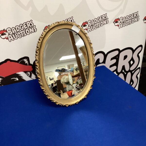 Vintage gold framed oval dressing table mirror for home décor.
