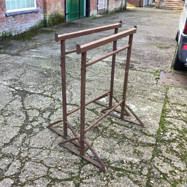 Pair of vintage wooden builders trestles in a garden setting.