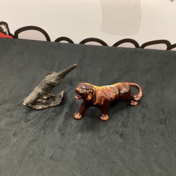 Vintage porcelain tiger and otter figurines, detailed animal collectibles.