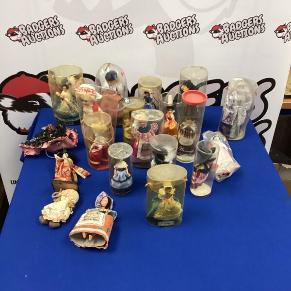 Quantity of vintage collectable dolls displayed on a surface.