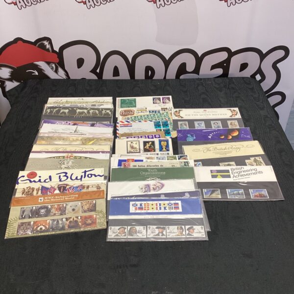 Collection of mint stamp packs from Great Britain for collectors.