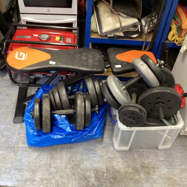 Used dumbbell weight set with folding bench for home fitness.