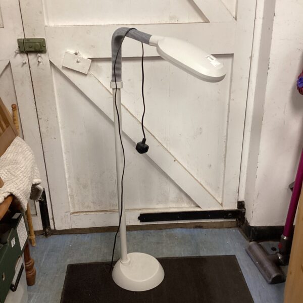 White reading floor lamp with flexible head and circular base.